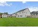 Wide view of a spacious backyard featuring a privacy fence, shed, and a manicured lawn at 277 Fiddleback Dr, Summerville, SC 29486
