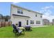 Cozy backyard with a patio, grill, fire pit, and chairs, perfect for outdoor relaxation at 277 Fiddleback Dr, Summerville, SC 29486