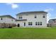 Spacious backyard features a lush green lawn, full wooden fence, and an extended patio area at 277 Fiddleback Dr, Summerville, SC 29486