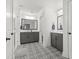 Bright bathroom featuring double vanity, decorative tile flooring, and a glass enclosed shower at 277 Fiddleback Dr, Summerville, SC 29486