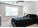 Elegant bedroom with a black bed, a window, and a side table at 277 Fiddleback Dr, Summerville, SC 29486