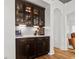 Elegant butler's pantry with glass front cabinets, granite countertops and wine cooler at 277 Fiddleback Dr, Summerville, SC 29486