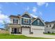 Charming two-story home with a manicured lawn, three car garage, and attractive blue and white color scheme at 277 Fiddleback Dr, Summerville, SC 29486