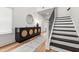 Bright foyer with modern console table, decorative mirror, and staircase with wood treads at 277 Fiddleback Dr, Summerville, SC 29486
