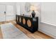 Inviting foyer with decorative console table, round mirror, and ample natural light at 277 Fiddleback Dr, Summerville, SC 29486