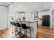Modern kitchen with white cabinets, stainless steel appliances, breakfast bar, and wood flooring at 277 Fiddleback Dr, Summerville, SC 29486