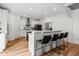 Open kitchen featuring white cabinets, an island with bar seating, and modern appliances at 277 Fiddleback Dr, Summerville, SC 29486