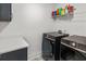 This functional laundry room is complete with modern washer and dryer units and storage cabinets at 277 Fiddleback Dr, Summerville, SC 29486