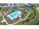 Aerial view of a community pool surrounded by lounge chairs, playgrounds, putting green, landscaping, and parking at 277 Fiddleback Dr, Summerville, SC 29486