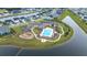 Aerial view of a community pool with a playground, putting green, pool house, parking and residential houses at 277 Fiddleback Dr, Summerville, SC 29486