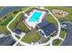 Aerial view of a community pool with lounge chairs, playground, parking, a pool house and putting green at 277 Fiddleback Dr, Summerville, SC 29486