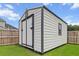 Storage shed on a well-maintained lawn with a black and white trim at 277 Fiddleback Dr, Summerville, SC 29486
