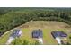 Traditional-style homes with paved driveways stand on grassy lots, offering a serene view of the nearby forest at 306 Mizell Rd, Dorchester, SC 29437