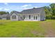 Backyard with a lawn and gray house siding at 306 Mizell Rd, Dorchester, SC 29437