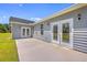 Home with a concrete patio and gray siding under a bright blue sky at 306 Mizell Rd, Dorchester, SC 29437