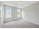 Bright bedroom featuring neutral carpet, two windows, and light gray walls at 306 Mizell Rd, Dorchester, SC 29437