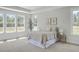 Light bedroom with multiple windows, tray ceiling, and neutral décor at 306 Mizell Rd, Dorchester, SC 29437