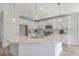 Kitchen with white cabinets, stone countertops, stainless steel appliances, and island at 306 Mizell Rd, Dorchester, SC 29437