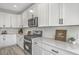 Modern kitchen with white cabinets, stone countertops, and stainless steel appliances at 306 Mizell Rd, Dorchester, SC 29437