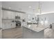 Kitchen with white cabinets, stone countertops, stainless steel appliances, and island at 306 Mizell Rd, Dorchester, SC 29437