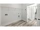 Laundry room featuring wood flooring and wire rack at 306 Mizell Rd, Dorchester, SC 29437