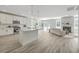 Open-concept kitchen and living area, featuring stainless steel appliances, an island, and a cozy fireplace at 306 Mizell Rd, Dorchester, SC 29437