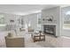 Sun-filled living room with fireplace, wood floors, large windows and comfortable seating at 306 Mizell Rd, Dorchester, SC 29437