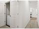 Hallway view showcases carpet flooring and a laundry closet with a white washing machine at 309 Sedona Dr, Summerville, SC 29486
