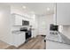 Well-equipped kitchen with white cabinets, granite countertops, stainless steel appliances, and light wood floors at 309 Sedona Dr, Summerville, SC 29486