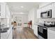 Open-concept kitchen flows into the living room with lots of natural light and a vintage writing desk at 309 Sedona Dr, Summerville, SC 29486