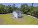 Aerial perspective of a new home with a green lawn, set against a backdrop of dense trees at 310 Mizell Rd, Dorchester, SC 29437