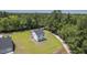 Aerial shot of new home with a large green yard adjacent to a sprawling forest at 310 Mizell Rd, Dorchester, SC 29437