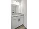 Elegant half-bathroom featuring a granite vanity top, white cabinets, and sleek black hardware at 310 Mizell Rd, Dorchester, SC 29437