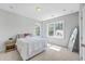 Bright bedroom with a full length mirror, light walls, carpet, and natural light from the nearby windows at 310 Mizell Rd, Dorchester, SC 29437
