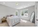 Bright bedroom with a full length mirror, light walls, carpet, and natural light from the nearby windows at 310 Mizell Rd, Dorchester, SC 29437
