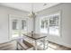 Charming dining area with bench seating, farmhouse-style table, and view to yard through glass doors at 310 Mizell Rd, Dorchester, SC 29437