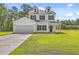 Two-story home featuring a manicured lawn, two-car garage, and classic white siding at 310 Mizell Rd, Dorchester, SC 29437