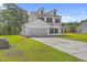 Two-story home featuring a large manicured lawn, two-car garage, and classic white siding at 310 Mizell Rd, Dorchester, SC 29437