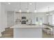 Contemporary kitchen with a spacious island, stainless steel appliances, white cabinets, and view to backyard at 310 Mizell Rd, Dorchester, SC 29437