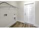 Clean laundry room with shelving, utility connections and an exit door at 310 Mizell Rd, Dorchester, SC 29437