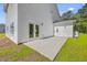 Backyard patio with double doors to the home and view of the lawn at 310 Mizell Rd, Dorchester, SC 29437