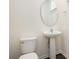 Powder room featuring a pedestal sink, round mirror, and white fixtures at 313 Catawba Branch Way, Moncks Corner, SC 29461