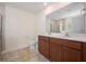 Bathroom featuring double sinks, dark wood cabinets, a large mirror, and a walk-in shower at 313 Catawba Branch Way, Moncks Corner, SC 29461
