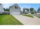 Two-story home with gray siding and a long driveway, surrounded by well-manicured lawns and other houses at 313 Catawba Branch Way, Moncks Corner, SC 29461