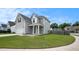 Two-story home featuring gray siding, white trim, a manicured lawn, and an attached garage at 313 Catawba Branch Way, Moncks Corner, SC 29461