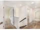 Upstairs hallway featuring carpet floors, a railing, and white walls and doors at 313 Catawba Branch Way, Moncks Corner, SC 29461