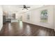 Spacious living area with hardwood floors, bright windows, and a ceiling fan, open to kitchen at 313 Catawba Branch Way, Moncks Corner, SC 29461