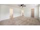 Spacious bedroom featuring neutral carpet, a ceiling fan, and access to an ensuite and walk-in closet at 313 Catawba Branch Way, Moncks Corner, SC 29461