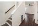 Bright staircase with wood treads and white risers, transitioning to dark wood flooring and an open space at 313 Catawba Branch Way, Moncks Corner, SC 29461