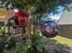 Backyard bird feeders and hanging planters add a burst of color and charm to the outdoor space at 346 Cicadas Song, Moncks Corner, SC 29461